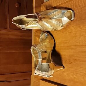 Goldtone mesh shoes with adornments.